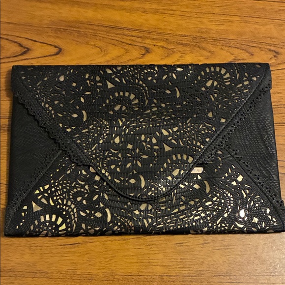 BCBGMaxAzria Handbags - BCBGMaxAzria Black Clutch with Gold Accent